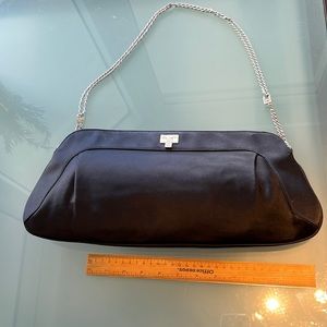 Woman’s big black satin clutch evening